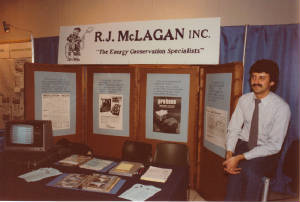 Picture of display booth with R.J.Mclagan, Inc. "Energy Conservation Specialists". Pictured is Ron McLagan and various equipment posters.